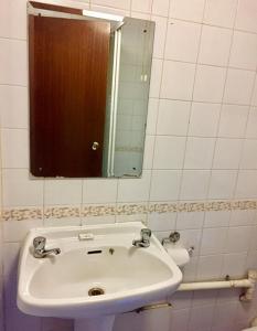 a bathroom with a sink and a mirror at Four Stars Hotel in London