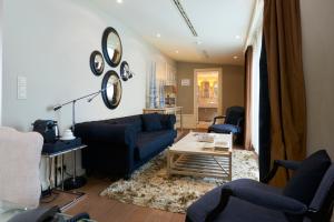 a living room with a blue couch and a table at Stanhope Hotel by Thon Hotels in Brussels