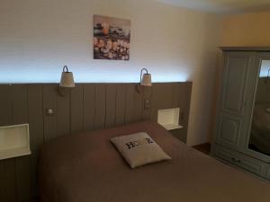 a bedroom with a bed with a pillow on it at Armalou in Pouilly-sur-Loire