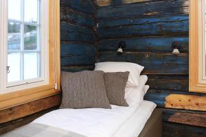 a white bed sitting under a window in a room at Bjerkeløkkja Bed and Breakfast in Oppdal