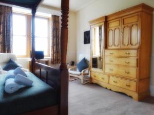 a bedroom with a bed and a dresser and a drawer at Kilchoan Hotel in Kilchoan