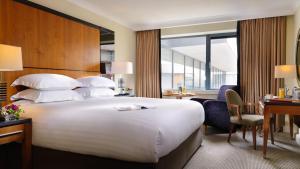 a hotel room with a large bed and a desk at The Galmont Hotel & Spa in Galway