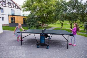 two girls playing ping pong on a ping pong table at Nielestno 34 in Nielestno