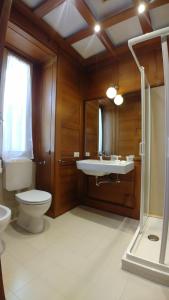 a bathroom with a toilet and a sink and a mirror at Appartamento La Torre in Lenno