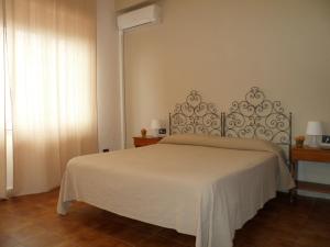 sypialnia z białym łóżkiem i oknem w obiekcie Hotel Panorama di Sicilia w mieście Castelmola
