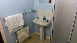 a small bathroom with a sink and a towel at The Windsor in Haverfordwest