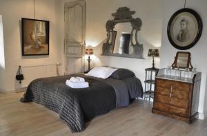a bedroom with a bed and a mirror on the wall at Le Relais de Roquefereau in Penne-dʼAgenais