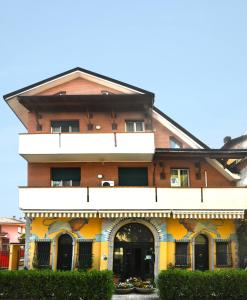 a large brick building with a store at Borromeo Residenze Service s.a.s in Peschiera Borromeo