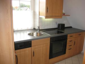 a kitchen with a sink and a counter top at Ferienhaus Uhlenhorst in Büsumer Deichhausen