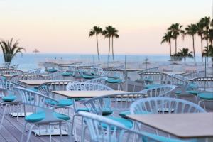 a row of tables and chairs on the beach at Iberostar Selection Sábila - Adults Only in Adeje