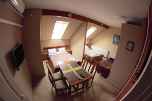 a room with a bed and a table and chairs at Müller's 2 in Siófok
