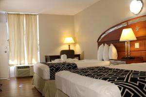 a hotel room with two beds and a window at Magic Key - Near Disney in Kissimmee