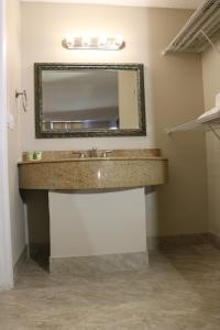 a bathroom with a sink and a mirror at Magic Key - Near Disney in Kissimmee