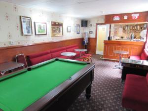 a billiard room with a pool table and a bar at Rhoslyn Hotel in Blackpool