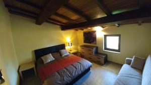 a bedroom with a bed and a couch at Casa Francesconi in Pietra Rossa +31 photos