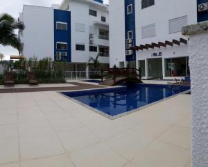 a swimming pool in front of a building at APTO fino área nobre dos Ingleses. 500m da praia! in Florianópolis