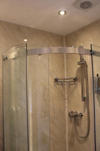 a shower with a glass door in a bathroom at Lindum Lodge in Torquay +80 photos