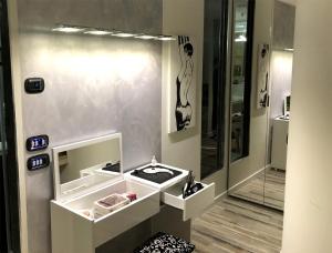 a bathroom with a sink and a mirror at Assisi Luxury SPA Suite in Assisi