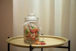 a glass jar filled with candy on a table at La-La Rooms in Zadar