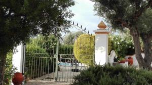 a gate with a fence with a chair behind it at Monte dos Aroeirais in Fronteira