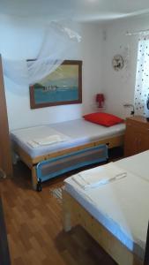 a room with two beds and a painting on the wall at Holiday Home Bah in Kruševo