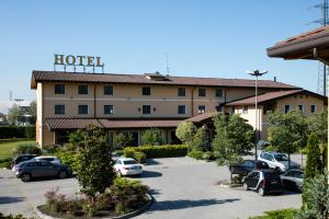 a hotel with cars parked in a parking lot at Hotel Del Parco in Vigevano
