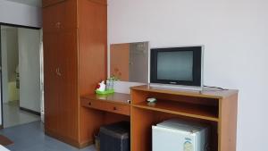 a room with a television on a wooden stand with a desk at Cha-Am Fish Star in Cha Am +56 photos