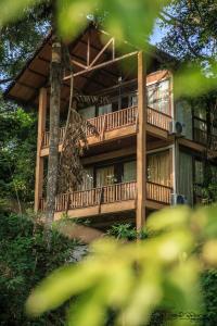 a large wooden building with a large deck at Jungle Village Unawatuna in Unawatuna
