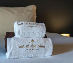 
a white towel laying on top of a white bed at Out of the Blue in Ponta Delgada
