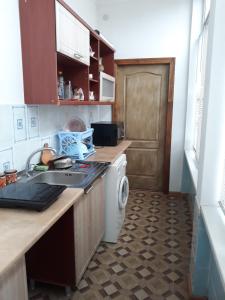 a kitchen with a sink and a washing machine at Сонячна in Truskavets