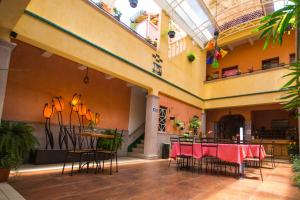 a room with tables and chairs in a building at Hotel Posada Santo Niño in Tacámbaro de Codallos