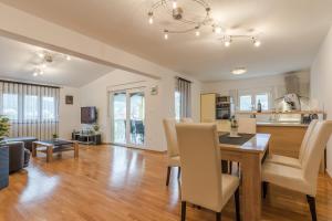 a dining room and living room with a table and chairs at Apartment Natalie Sea View with 3 Bedrooms and everything is air-conditioned in Sali
