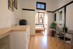 a kitchen with a sink and a bathroom with a tub at Traditional Apartments Alexandra in Meyisti