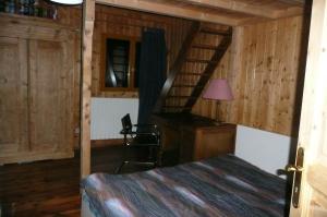 a bedroom with a staircase in a wooden cabin at Chalet Vaclav in Sixt