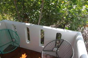 a white couch sitting next to a wooden fence at Hotel Villa Mozart y Macondo in Puerto Escondido
