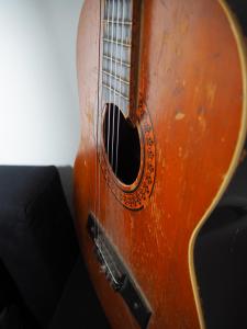 a close up of a wooden acoustic guitar at Sleep Inn Hostel in Bucharest