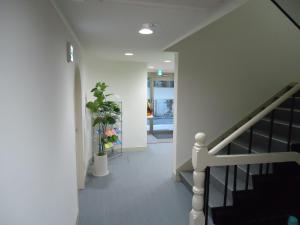 a hallway with a staircase and a stair case at Shin-Okubo City Hotel in Tokyo