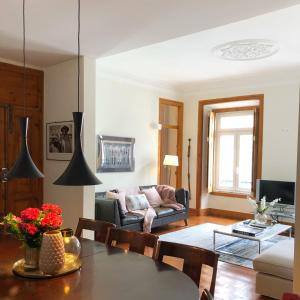 a living room with a table and a couch at Bairro Alto in Lisbon