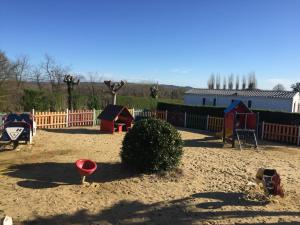 a childrens playground with a sandbox and play equipment at la ferme des 4 chenes in Urt