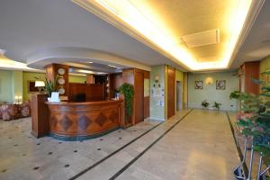 a lobby with a reception desk in a building at Sun Hotel in Rubiera