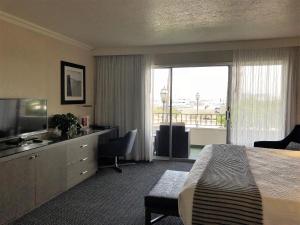 a hotel room with a bed and a large window at West Beach Inn, a Coast Hotel in Santa Barbara