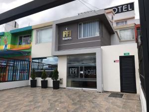 a store front of a building with potted plants at Hotel Tempus in Pasto