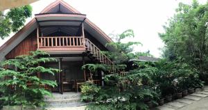 a house with a deck on the side of it at Theresa's Pension House in San Vicente