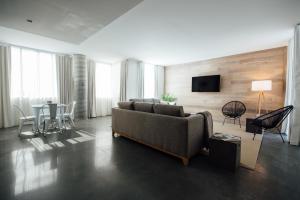 a living room with a couch and a table at The Preston House and Hotel in Riverhead