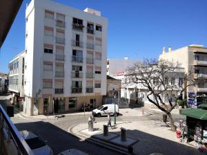 a white van parked in front of a building at Faro Downtown Holiday Apartment in Faro