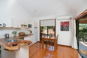 a kitchen with a wooden counter top and a table at Limpinwood Lodge in Limpinwood