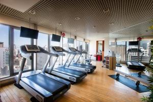 a gym with a row of treadmills in a building at Ibis Ambassador Myeongdong in Seoul
