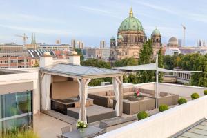 a rooftop patio with a gazebo on a building at Monbijou Penthouse by Suite030 in Berlin
