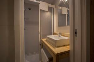 a bathroom with a sink and a shower at Tramura Guest House in Trapani