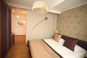 Postel nebo postele na pokoji v ubytování Hotel La Roseraie